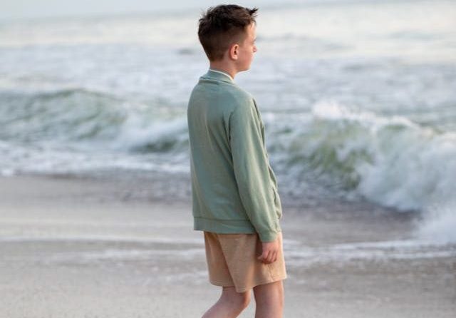 boy walking on the beach