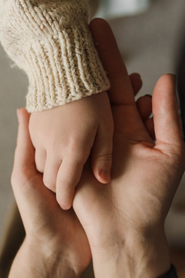 child holding parents hand